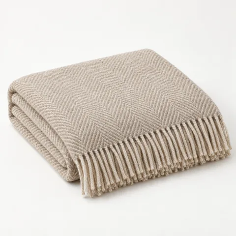 A folded oatmeal wool throw